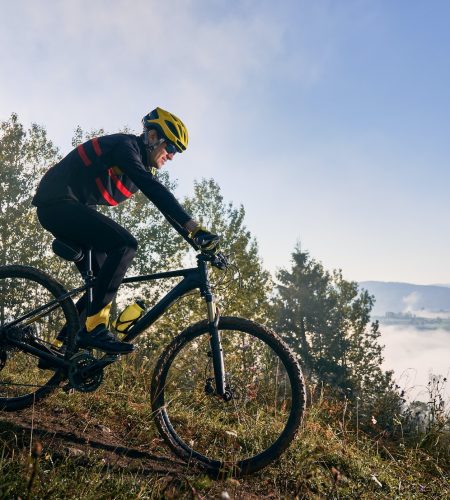 young-man-riding-bicycle-in-the-mountains-in-early-morning.jpg